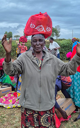 A widow receiving aid during an outreach event