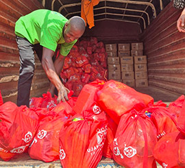 A man organizes bags of supplies for an outreach event