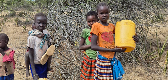 Children standing with their water containers