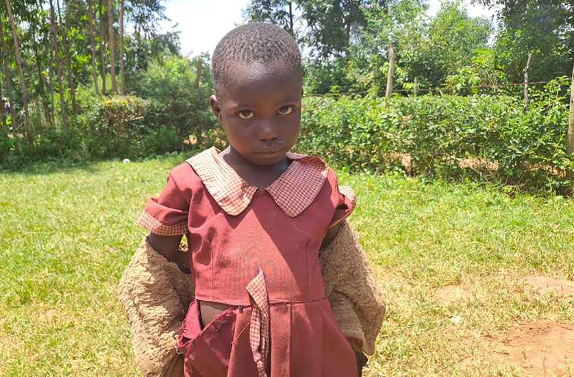 A young girl looking at the camera somberly