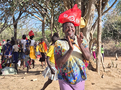 A widow walks away joyfully with her bag of Christmas goods