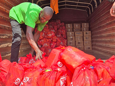 A man organizes bags of supplies for an outreach event